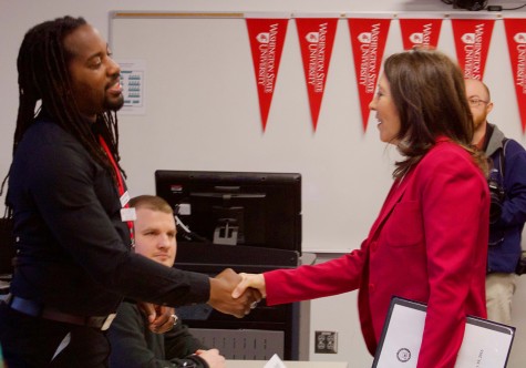 Sen. Maria Cantwell shakes hands with student body president Azrael Howell