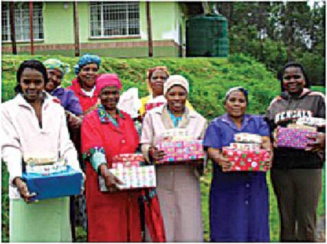 Caretakers holding their Christmas presents; for some it was the first Christmas gift they had ever received.