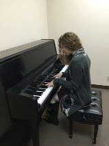 Students Hannah Gould using the practice rooms to practice her own music.
