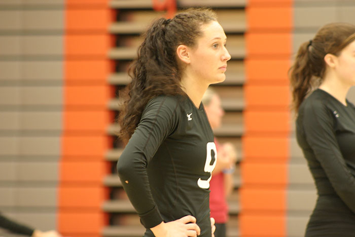 Leilani Hansen waits for the ref to decide who gets the ball after a supposed hand went over the net.