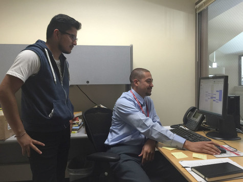 Omar Marquez (right) with student Segio Jose Barrera (left) scheduling a meeting. // Diana Pinon