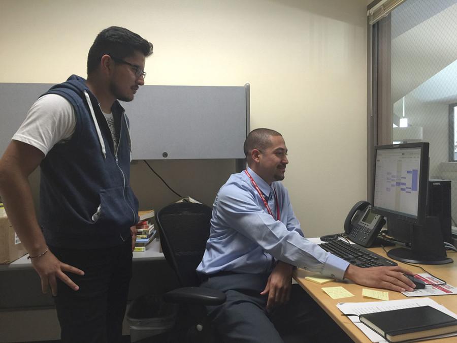  Omar Marquez (right) with student Segio Jose Barrera (left) scheduling a meeting. // Diana Pinon
