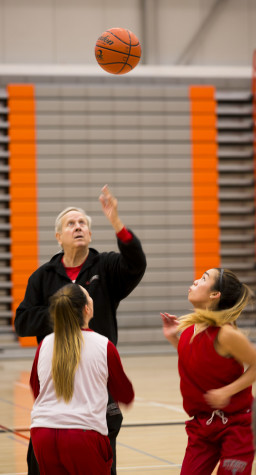 Coach Chet Hovde throwing up the jump ball for his players, during a 5 on 5 drill at practice on Oct 26 2015.