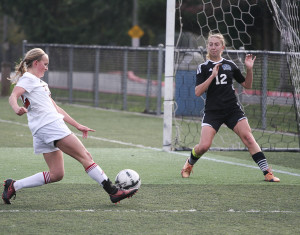 While shielding away the defender, Claire Nelson pushes the ball upfield against Tacoma Community College Wednesday afternoon on Nov. 4, at Kasch Park.