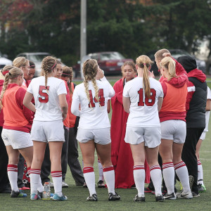 The Trojans huddled up at halftime talking strategy, during their 4-0 victory over Tacoma Community College Wednesday afternoon, in their first round matchup at Kasch Park.