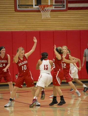  Makaliah Johnson for EvCC splitting a double team, with the defense of Skagit Valley clamping down on the Trojan offense. // Michael Rhodes