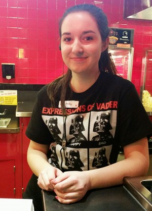 Abby Tutor stands in concessions, smiling through the pain, sporting a Darth Vader shirt.