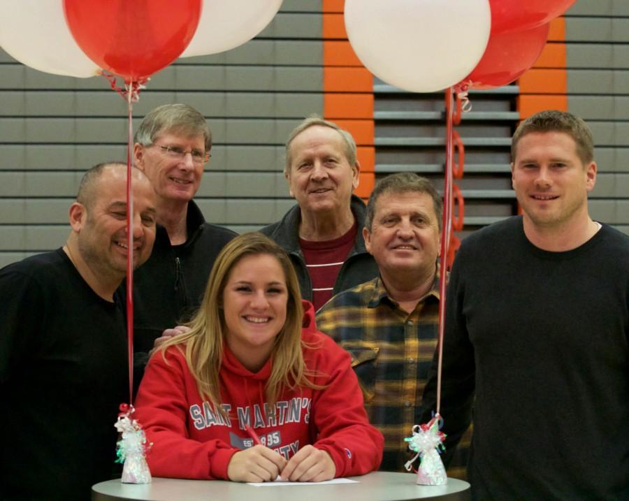 Allison with soccer coach Geoff Kittles (far right) and basketball coach Chet Hovde (in the middle) all gathered together for a picture after the signing on Wednesday, Feb. 3. Also on hand was Athletic Director Larry Walker in the photo.