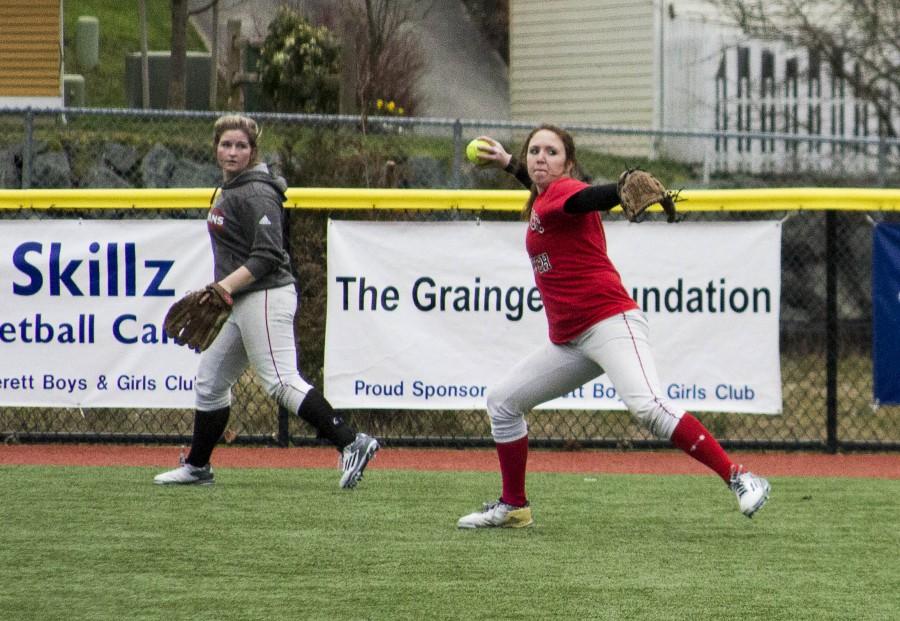 Rylee Thomas (right) throws to the cut off during outfield practice while Abigail Bauthues looks on, on March 2, 2016 at Everett’s softball field. 
 