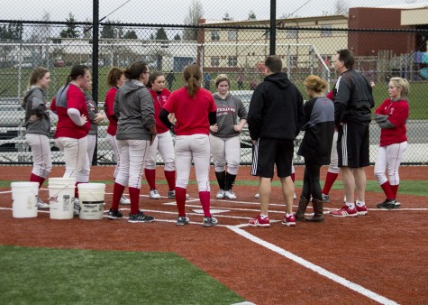 Coach Smith leads a team meeting to wrap up practice on March 2, 2016 at Everett’s softball field. 