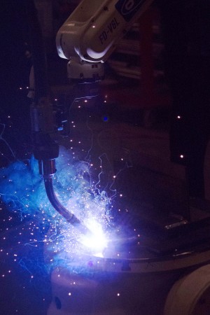 Air Gas’s robotic welding arm in action. Metal name tags engraved with “Air Gas” were submitted to the flame.