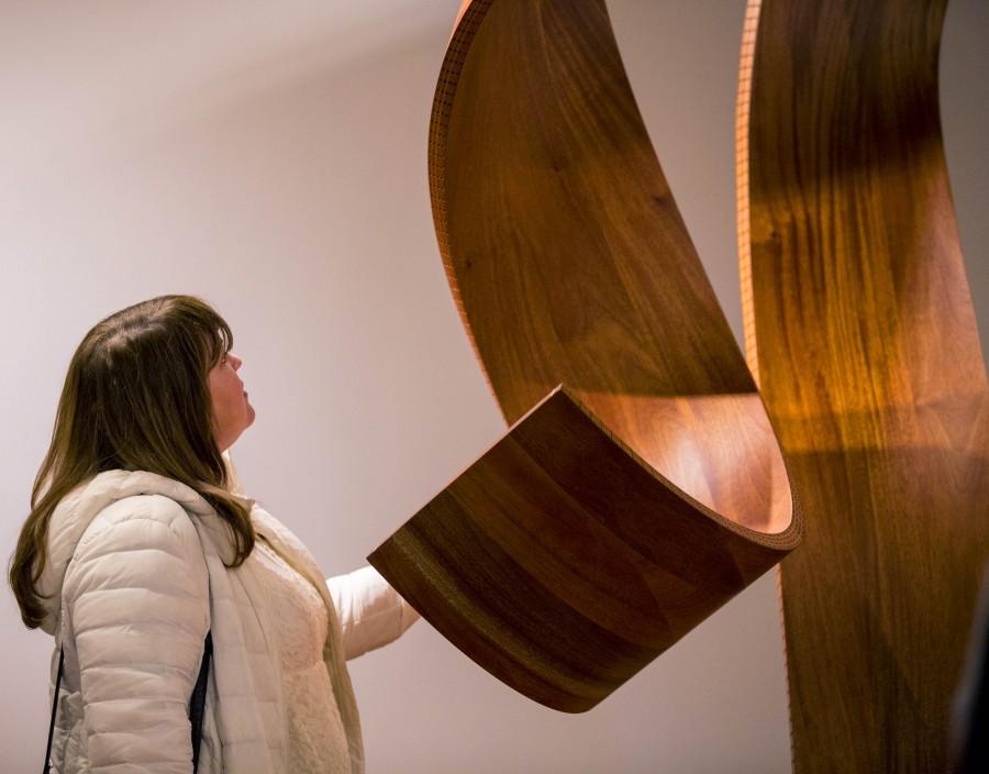 A student looking at one of Paul Vexler’s wooden sculptures at the Russell Day Gallery on Feb. 18.