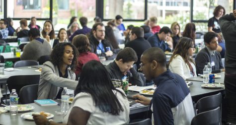 Conference attendants and presenters eating lunch and talking during the break.
