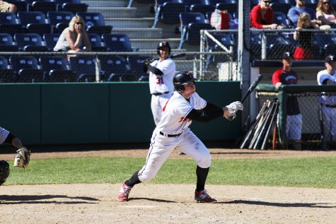 Knocking the ball deep in the outfield, Jake Nelson watches the ball leave his bat against Shoreline Community College.