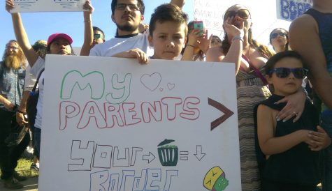 EvCC student Sergio Barrera stands in protest along with young Antonio Mariscal at the Trump rally in Lynden, WA on May 7, 2016. Many protesters attending the rally from all over the Pacific Northwest.