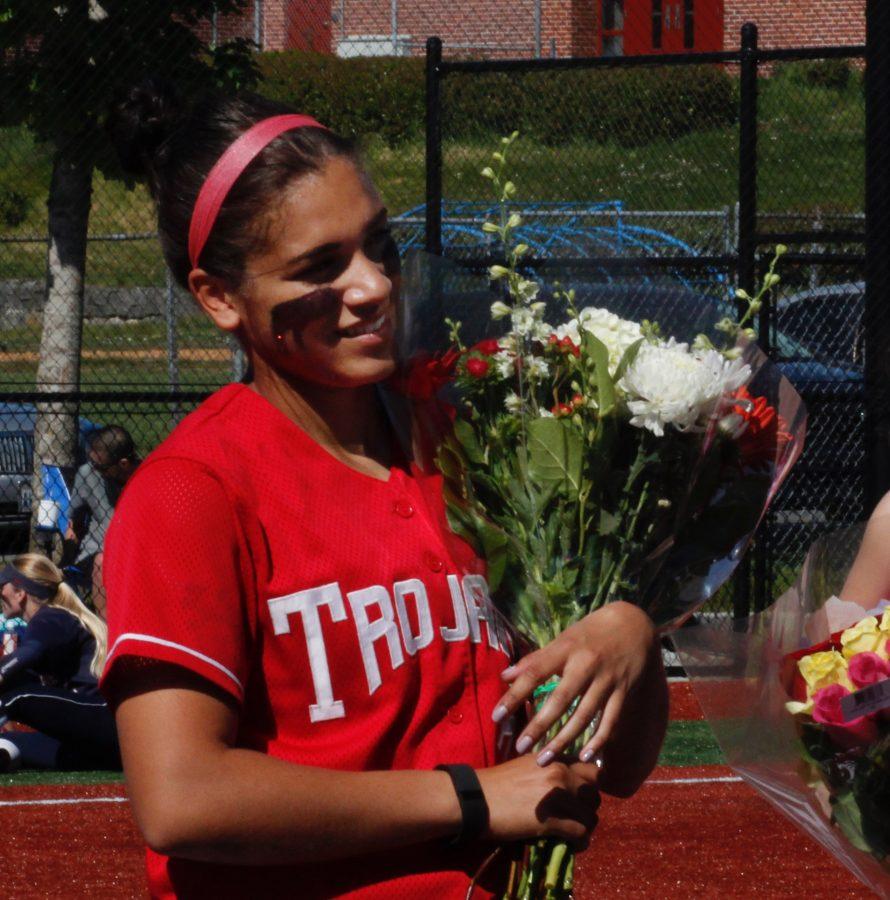 Sophomore Taryn Salter receives a bouquet of flowers from Head Coach Randy Smith on sophomore day at Gaffney Field in front of her family and friends.