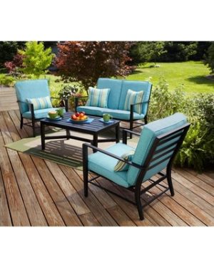 Patio Furniture surrounded by tons of plant life on a summer night. 