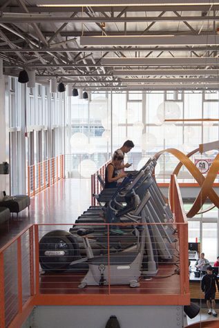 Two people are using the treadmills on the second floor of the Fitness Center. Women were playing basketball in the gym on Oct. 3 but all other areas were open for use. 