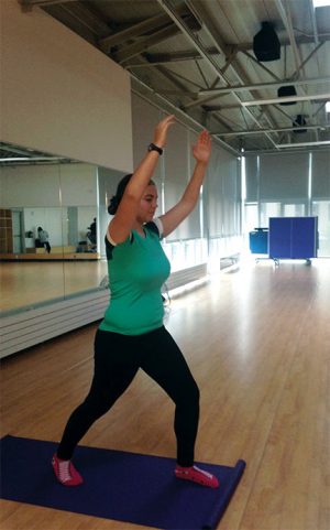 Yoga student, Teagan Fife, demonstrates the Warrior Pose during Anderson’s morning Beginning Yoga class.