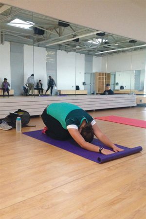 Teagan Fife, a yoga student in Anderson’s 8 o’clock morning class, demonstrates the popular Child’s Pose.