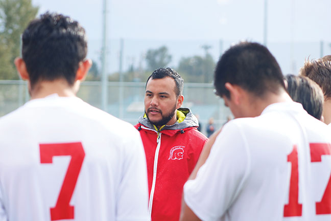 EVCC Mens Head Soccer Coach, Eric Cruz, addresses the team at halftime against Shoreline on Saturday.