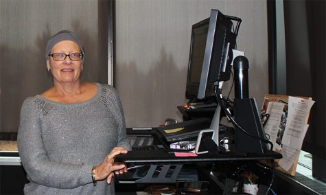Lori works from her desk.