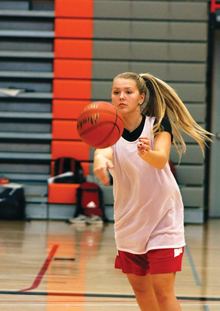 Freshmen captain Ashley Bierer passes around the perimeter in one of many offensive practice drills.