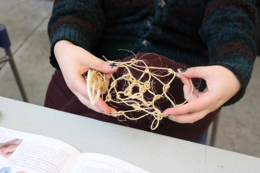 Kristen Kelsey displays her fishnet knotting creation. 
