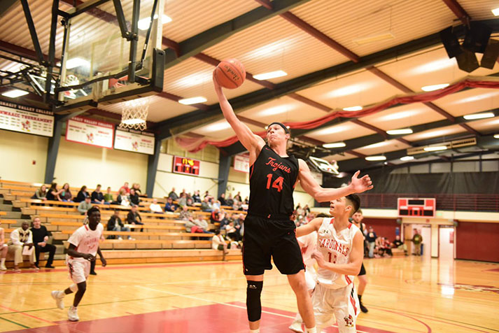 Conner Moffatt drives to the rim against Skagit wearing the team’s new black Nike jersey.