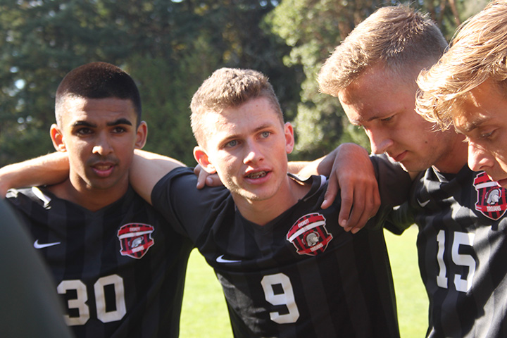 Gregor Byrne ( middle ) rallies his teammates in a pre-match huddle before their  match against Shoreline on October 6. 