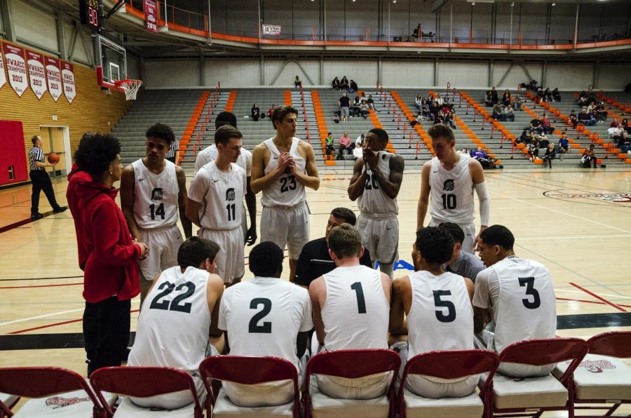 Head+Coach+Mike+Trautman+discusses++game+tactics+to+the+team+during+a+timeout+on+February+6+against+Skagit+Valley.