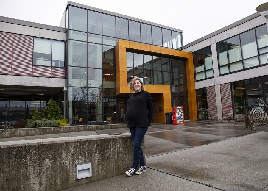 Kaitlin Morgan, smiles proudly while standing in front of Whitehorse Hall. After tiring of working low-wage jobs, she has come back to school to earn her degree.