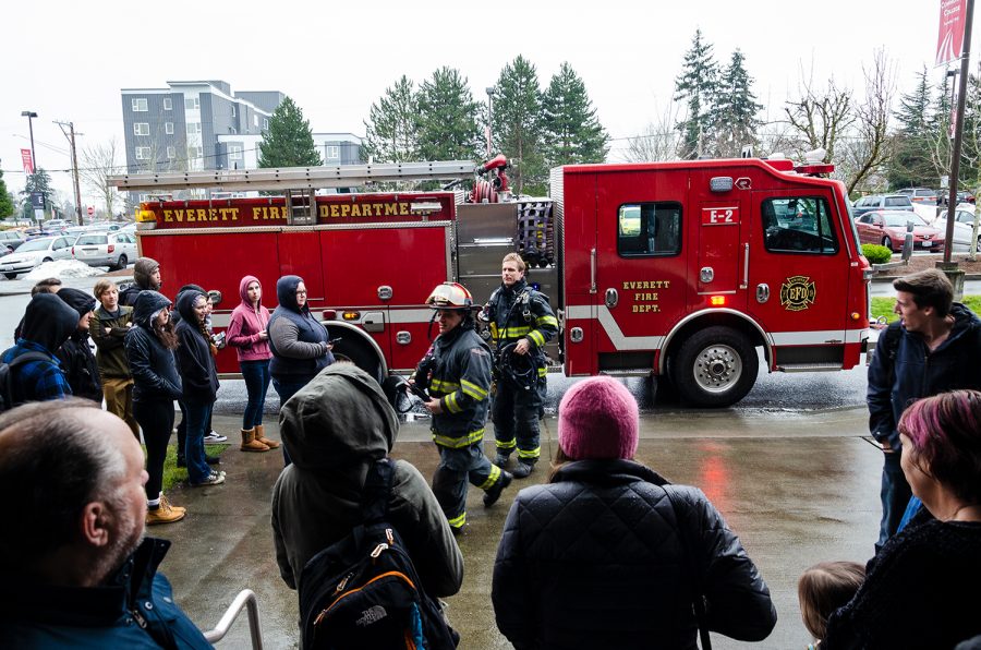 Everett firefighters responding to a smoke detector going off. Students evacuated from the building, standing outside Whitehorse Hall.