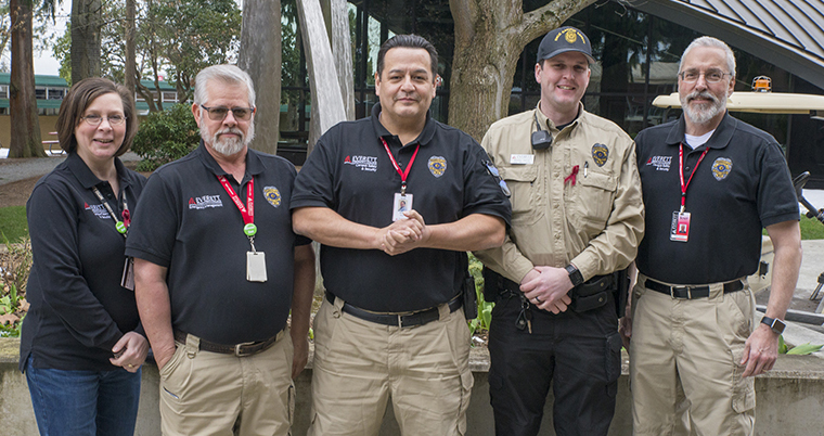 Security guard Nicholas Aldrich (second to the right) standing with his fellow safety, security and emergency management crew. 