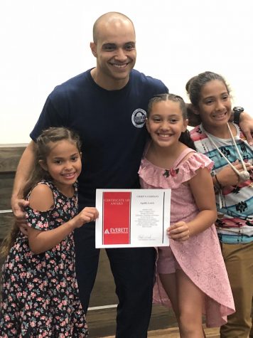 Lewis with his children at the EvCC Fire Academy
graduation, Summer 2018.