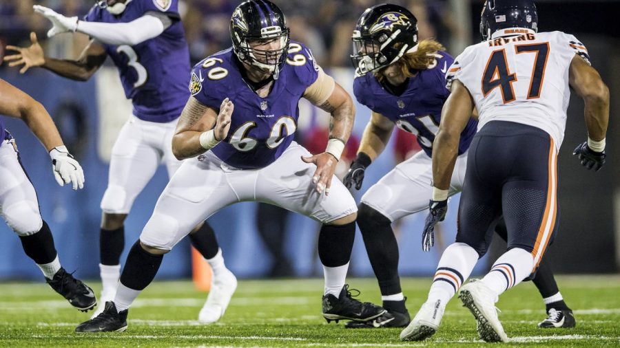 Crecelius (left) blocking in a preseason game against the Bears. 