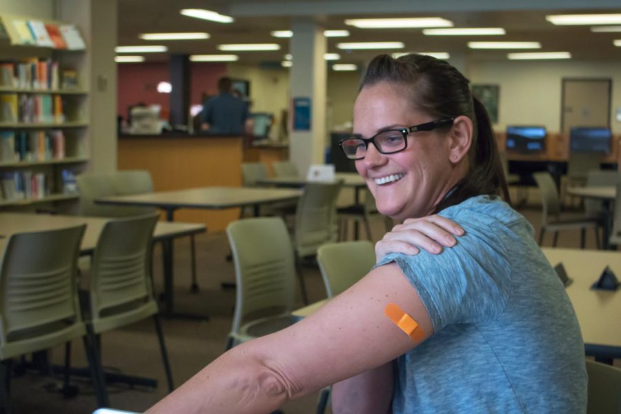 Johanna Van Dam, 34 years old, shows off her allergy shot bandage.