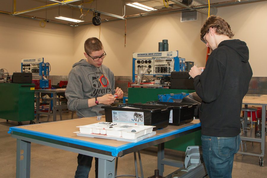 Students Connor Crowley (left) and Bennet Svob (right), work on a project using Legos in a mechanical electronics class at EvCCs Advanced Manufacturing Training and Education Center (AMTEC).
