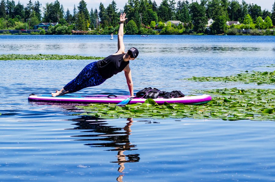 Keely Maroney, a yoga instructor, practicing stand up paddleboarding (SUP) yoga on Silver Lake.