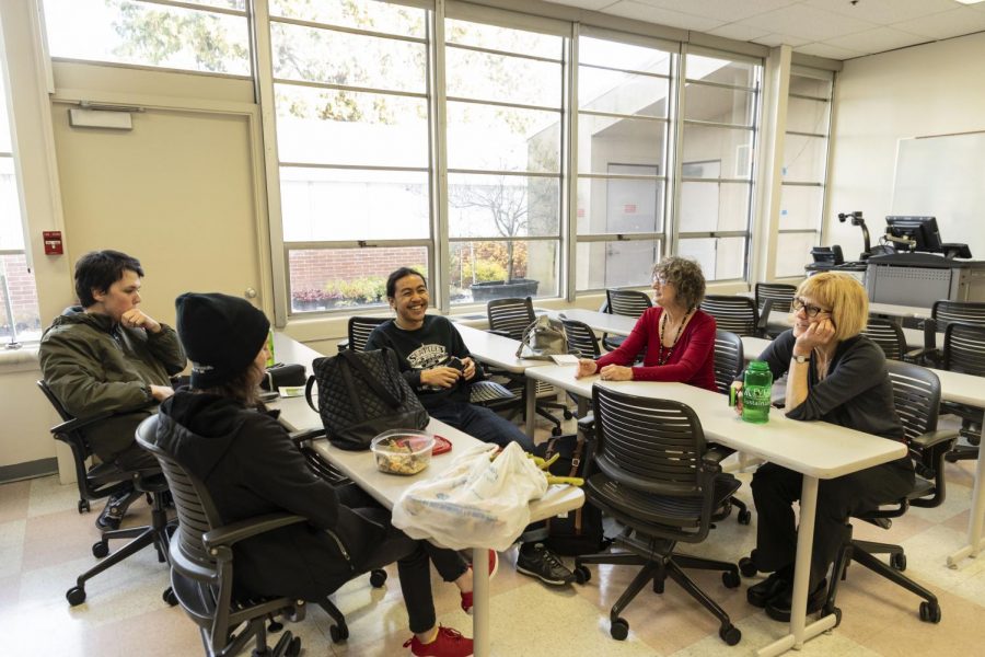 (Left to right) EvCC SEA clubs advisors Laura Wild, and Nancy Vandenberg sit with members during a club meeting.  