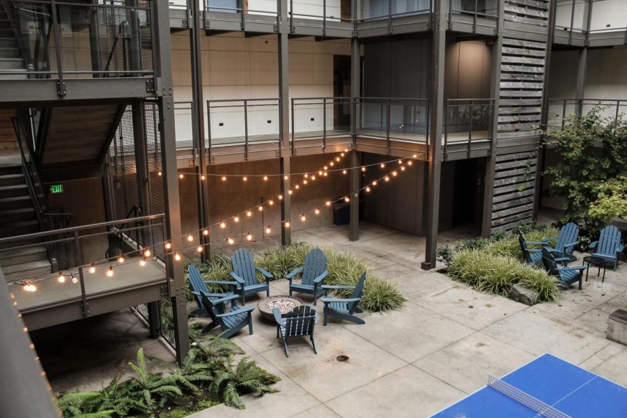 Courtyard at Cedar Hall dorm including ping-pong tables and fire pits.