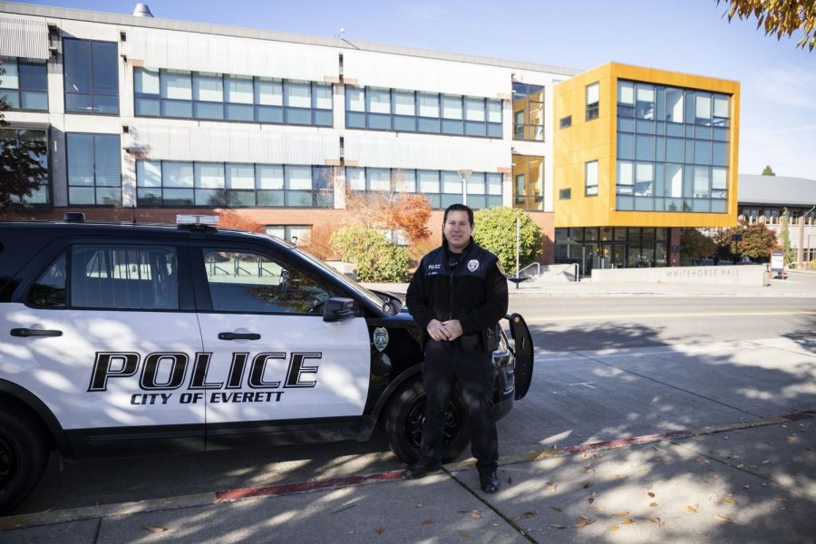 Everett Police Department’s Public Information Officer, Aaron Snell stands next to his patrol car and explains the close work between the EvCC’s Security Office and the Everett Police Department outside of White Horse Hall on Wednesday, Oct. 30.
