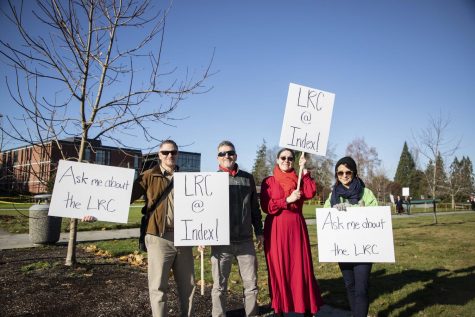(From left to right) EvCC faculty, Mike VanQuickenborne, Robert Bertoldi, Heather Jean Uhl and Miki Aspree display their picket signs at the LRC protest on Wednesday, Nov. 20 at the Index greenspace.