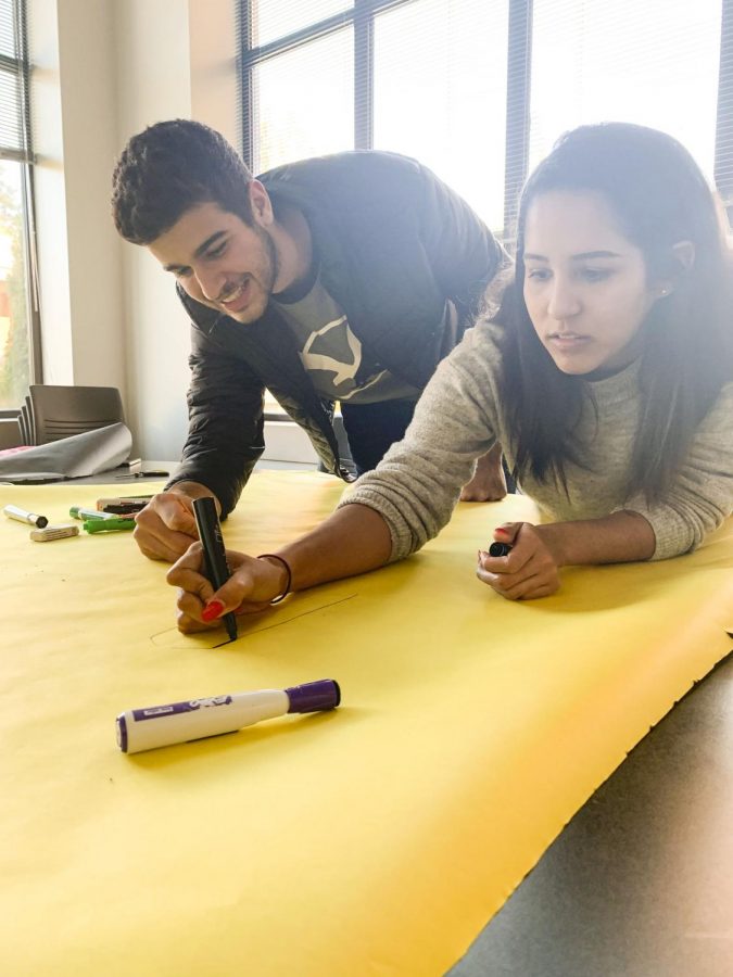 Club members, Vitor Cardozo and Leysky
Fernandez, preparing a sign inviting students to join the new Hispanic and Latinx Club.