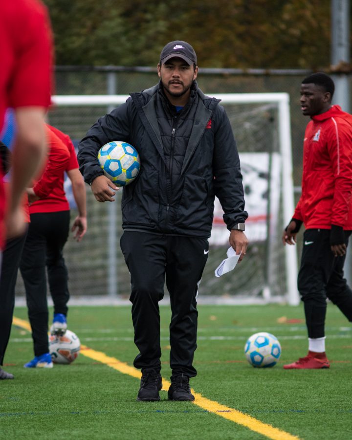 Erik Cruz, on the field at Kasch Park, coaching the EvCC Mens soccer team.