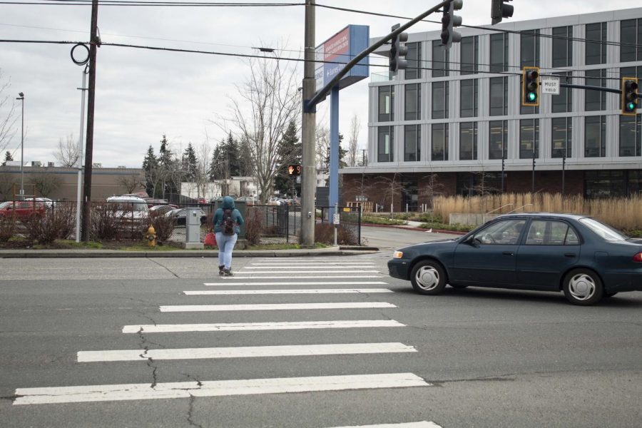 A car closely approaches a pedestrian crossing the street at the North Broadway Ave. and Tower St. intersection. When the LRC is relocated this is one of the crosswalks that students will have to use. 