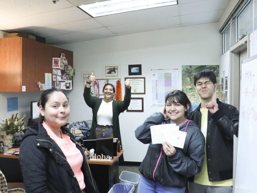 Members of Conversation Pal, participating in a stamp collecting game in the office of Emma Kaahaaina, EvCC Diversity & Equity Center Program Manager on Feb. 25, 2020.
