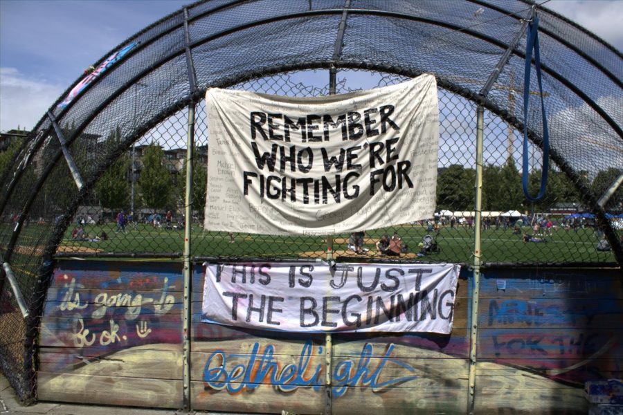 Banners+reading+Remember+Who+We+Are+Fighting+For+and+This+Is+Just+The+Beginning+are+hung+at+Cal+Anderson+Park+in+the+area+of+the+Capitol+Hill+Occupied+Protest+%28CHOP%29.
