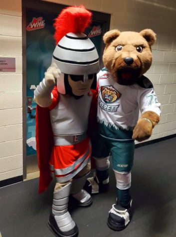 Trojan (EvCC mascot) and Lincoln (Silvertips Mascot) pose for a photo together.