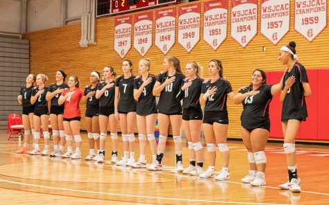 The 21-22 EvCC Volleyball Team together, pledging towards the national anthem, during the Sept 24th game against the Shoreline Dolphins.